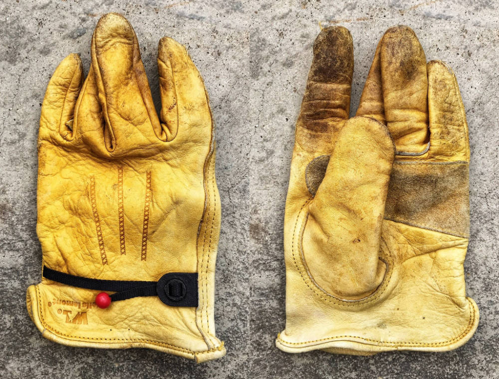 A pair of well-worn Wells Lamont gloves.