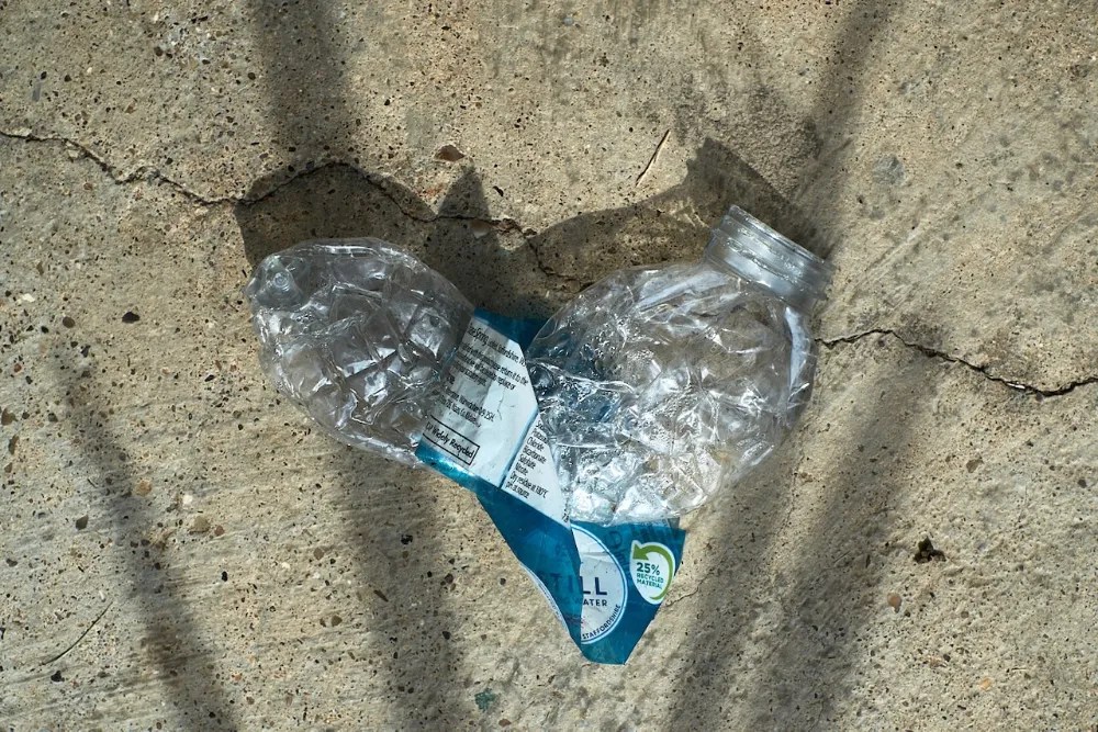 A discarded plastic water bottle in beautiful light.
