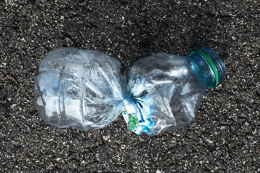A discarded plastic water bottle that has been twisted.